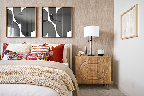 modern bedroom with neutral wallpaper and graphic art