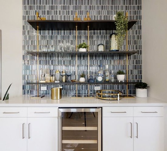 home bar with tile backsplash and gold accents