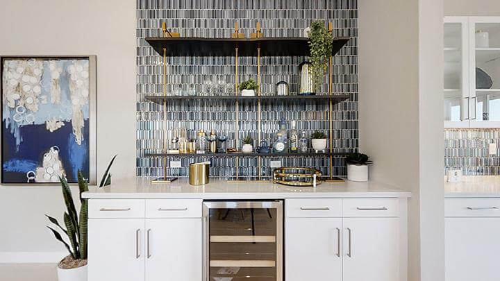 home bar with tile backsplash and gold accents