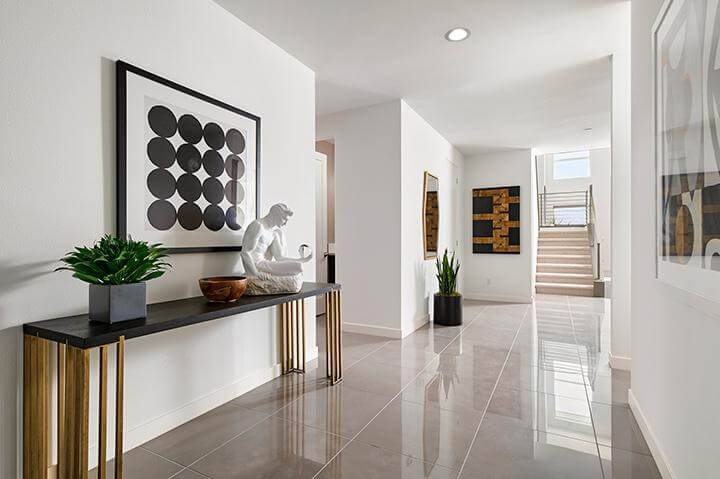 white entryway with gold accents