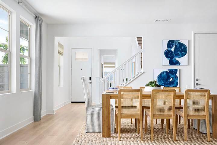 bright entryway and dining room with rattan furniture
