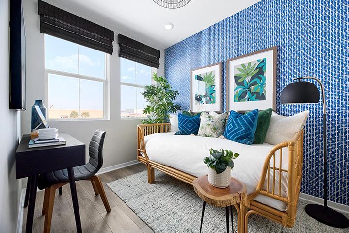 flex room with blue wallpaper and floral pictures