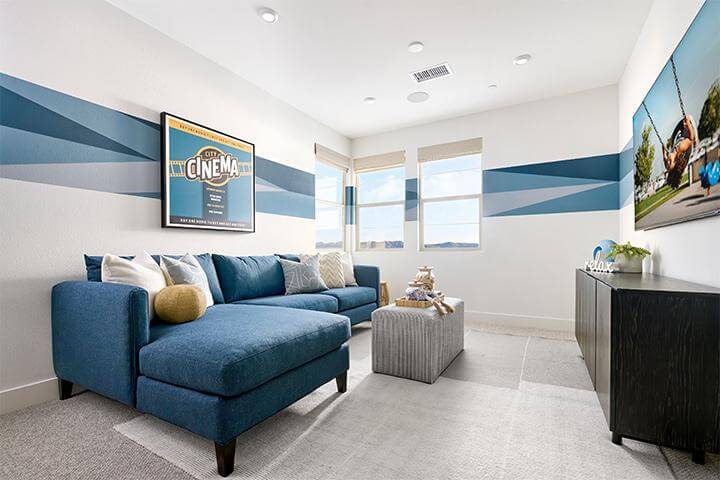flex room with blue sectional and graphic wall stripe