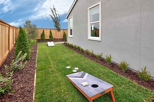 grassy outdoor area with bean bag game