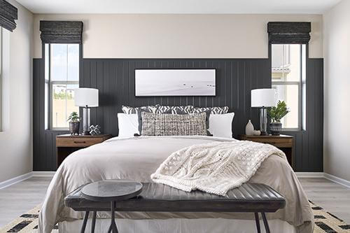 bedroom with dark gray millwork statement wall