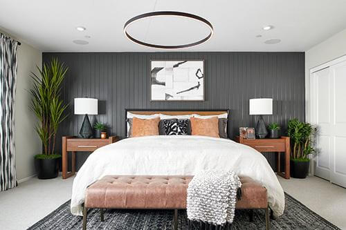 modern primary bedroom with tufted bench