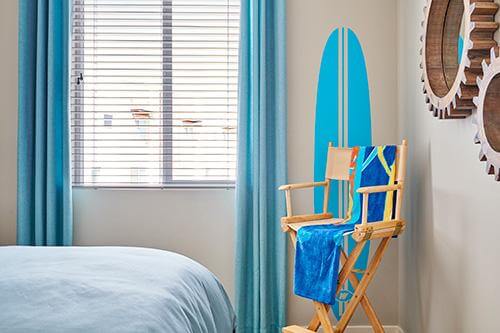 bedroom with surf board and beach chair