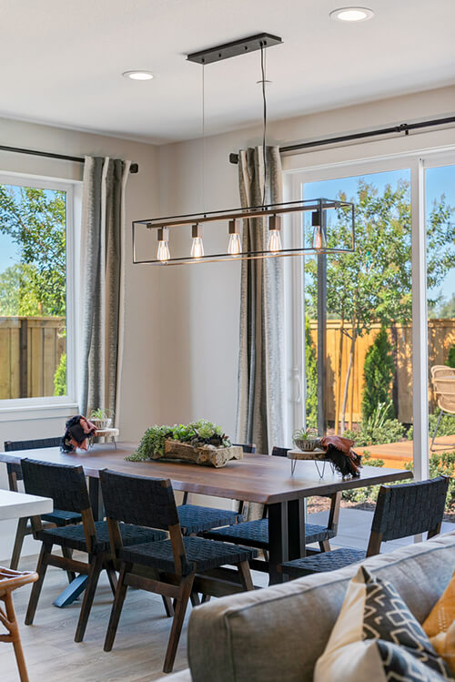 a dining room with a long chandelier