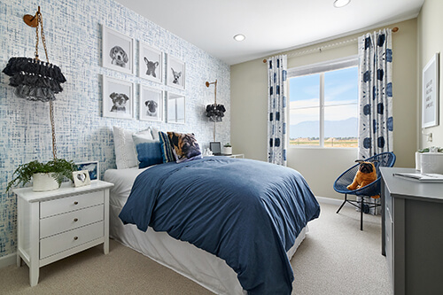 a bedroom with chandeliers above nightstands