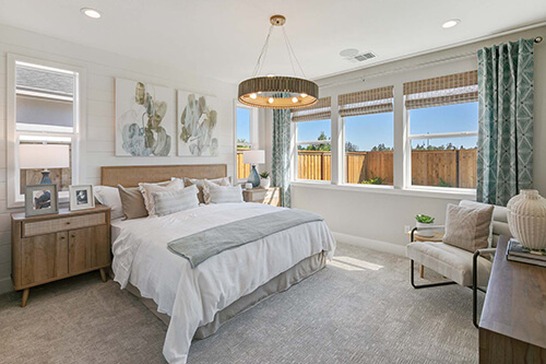 a bedroom with a fenced chandelier