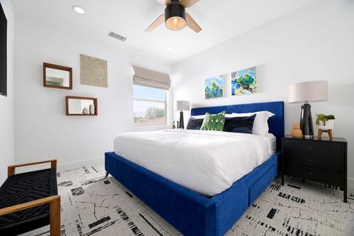 neutral bedroom with cobalt blue bed frame