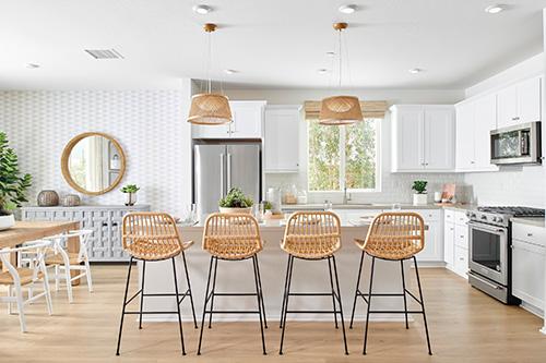 warm kitchen with wicker barstools and pendant light fixtures