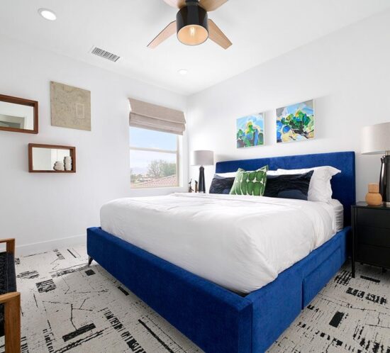 large bedroom with blue velvet bed