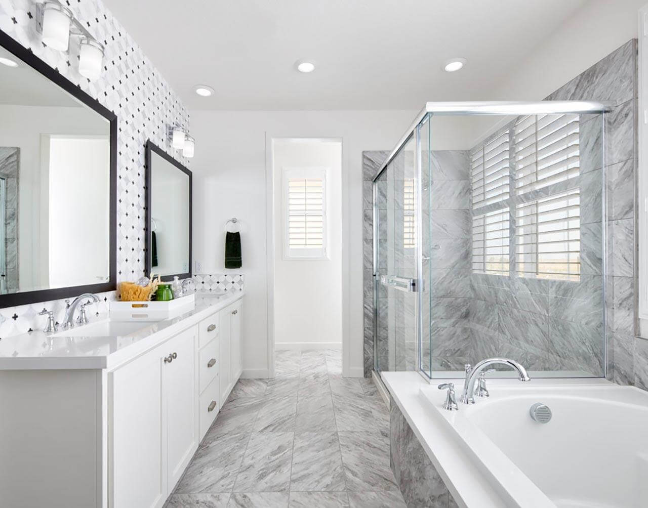 white marble ensuite bathroom with tub