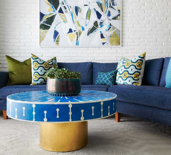 living room with blue couch and round coffee table