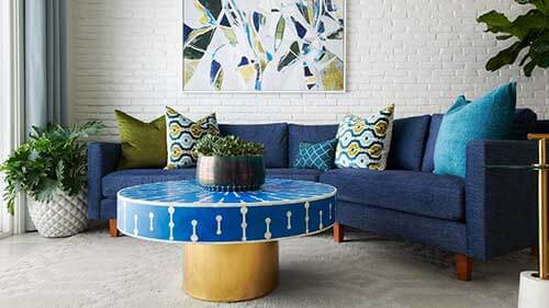 living room with blue couch and round coffee table
