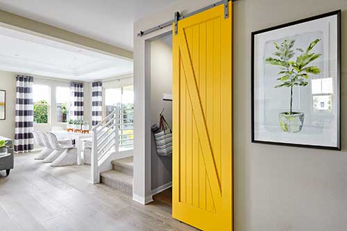 yellow barn door to powder room