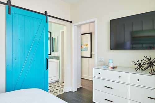 guest room with bright blue barn door