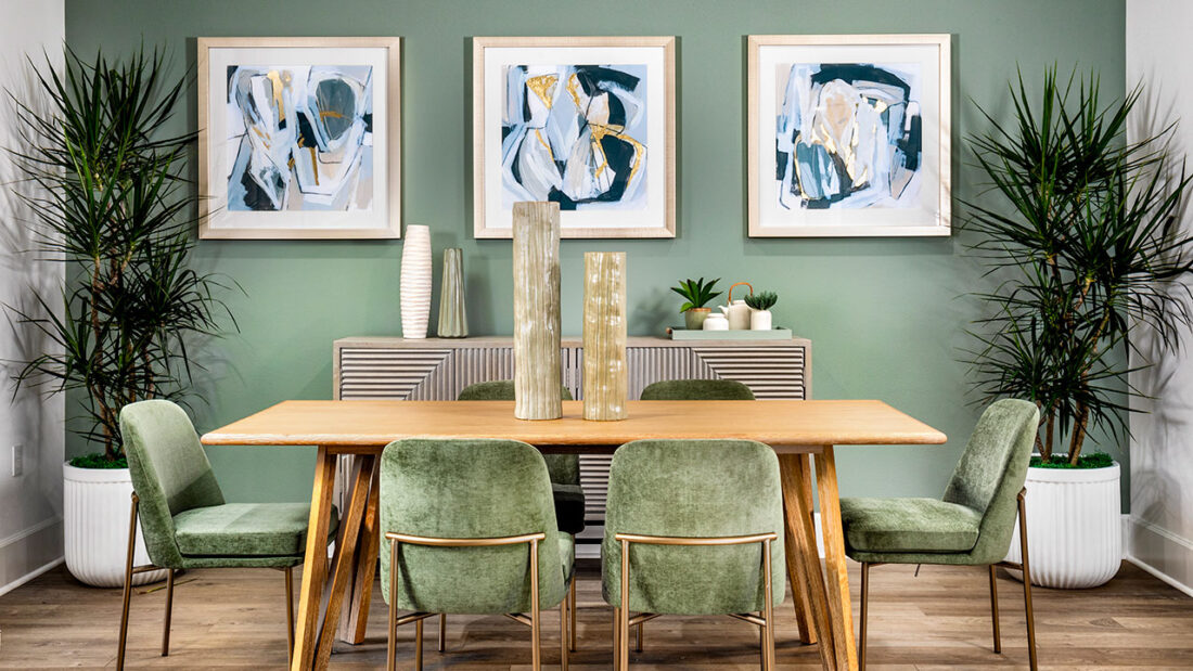green dining room with modern art