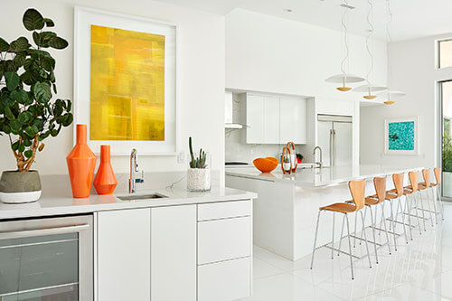 white kitchen with orange ceramic decor