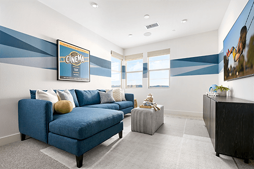 flex room with blue sectional and dimensional wallpaper